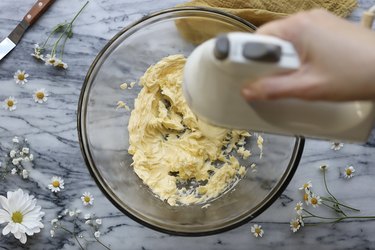 Beating butter in a mixing bowl with a hand mixer