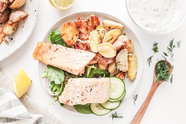 Baked salmon and crispy Parmesan potatoes with dill dressing