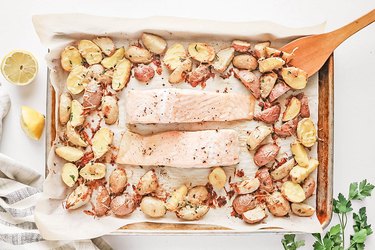 Baked salmon and potatoes on a baking sheet