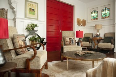 great room with red doors and various chairs near a round table