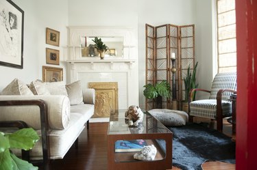 a seating area with a couch, coffee table, and chair, near a fireplace