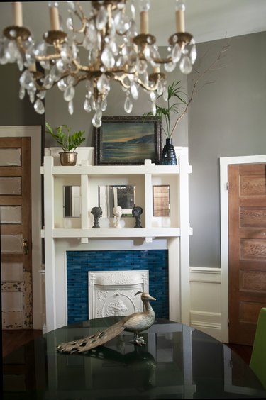 fireplace mantel with large chandelier above