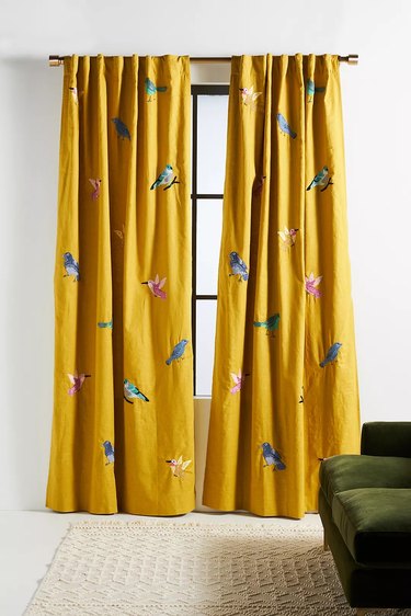 gold curtains with embroidered birds