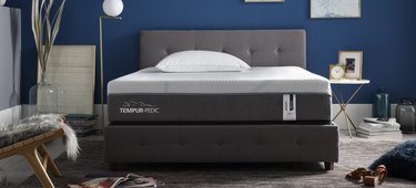 Gray and white mattress atop a gray bedframe