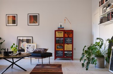 Room with greige walls and red accent cabinet