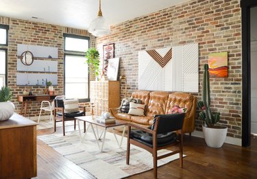 vintage and modern living room with brick accent wall