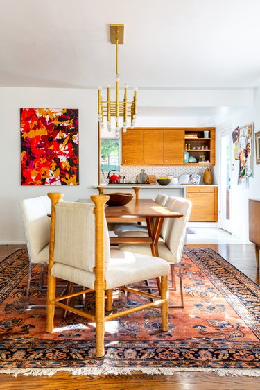 vintage and modern dining room with colorful abstract artwork