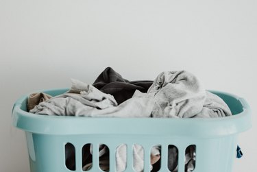 Blue hamper filled with laundry