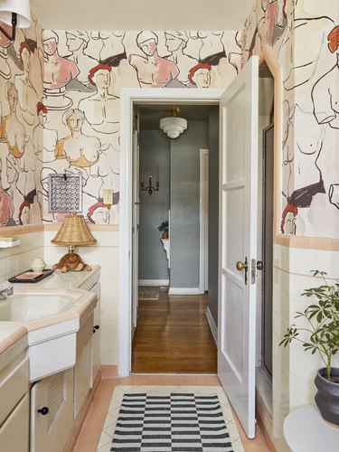 Modern maximalist bathroom with pink hues and bold print wallpaper