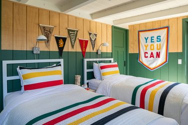 green and wood clad bedroom with primary colors