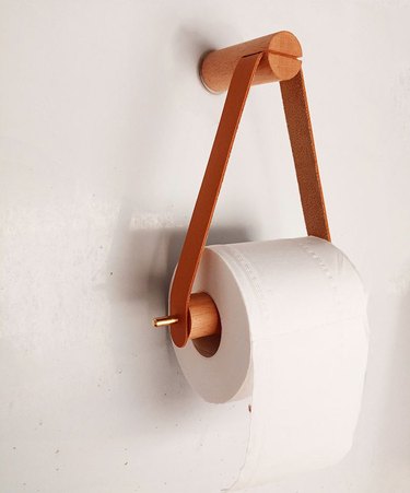 wall-mounted faux leather and wood toilet paper holder