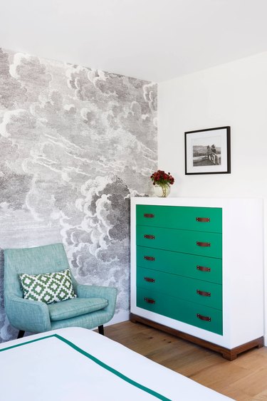 bedroom with kelly green dresser and gray tone cloud wallpaper