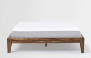 Silk & Snow wooden bed against a white backdrop