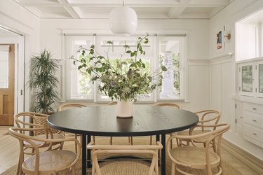 dining room with round table with light wood chairs and built-in storage
