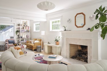 white living room with curved sofa and fireplace