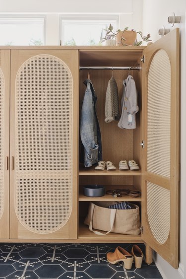 mudroom with storage cabinet for rain boots, coats, and umbrellas