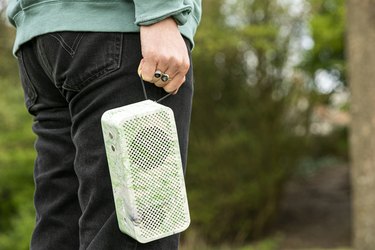 photo of a person holding a gomi speaker outdoors