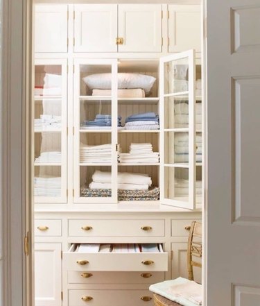 Built-in linen closet cabinets and drawers.