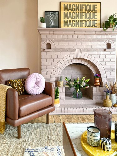 mustard yellow decor details with light pink fireplace