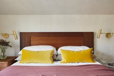 mustard yellow throw pillows with dark pink bedding