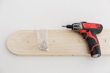 Drill screws up through the back of the wood board.