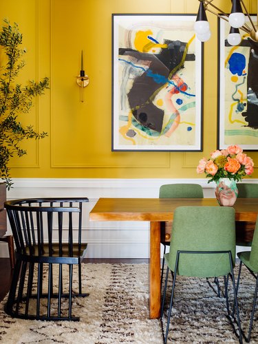 sage green dining chairs with mustard yellow walls