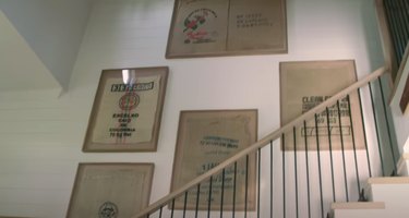 framed coffee bags on wall near staircase