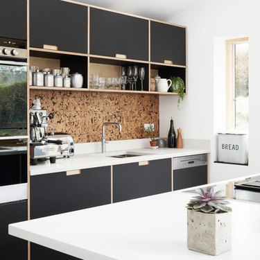 black plywood kitchen with inexpensive cork backsplash