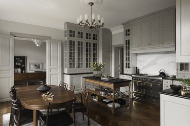 Kitchen with gray cabinets and dark wood floors.