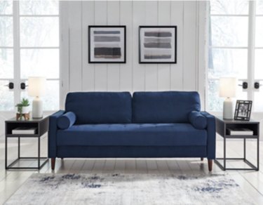 modern dark blue velvet sofa with bolster pillows and usb ports