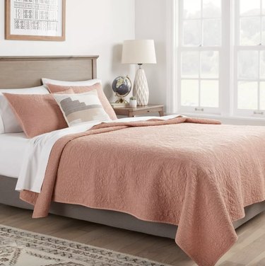 Target terracotta quilt in a white bedroom