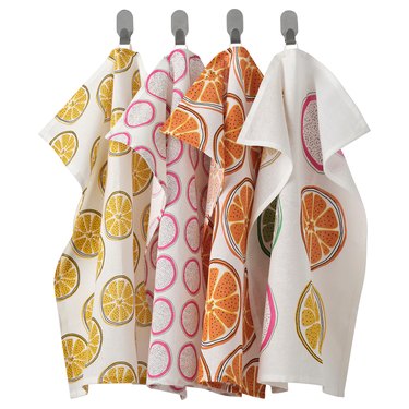 four towels in orange and white patterns