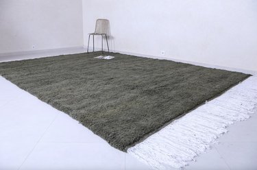 green rug with white fringe