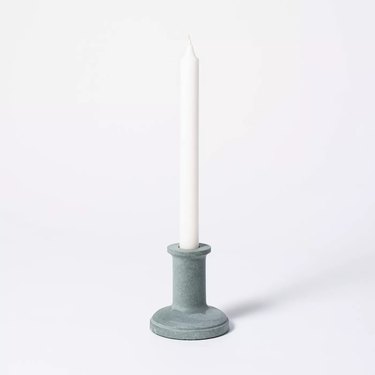 white candlestick in soapstone candlestick holder