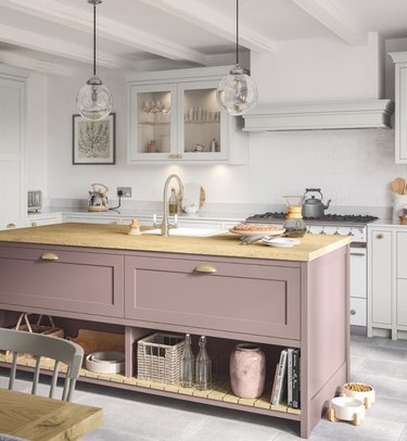 Kitchen with lilac colored island, gray floors.