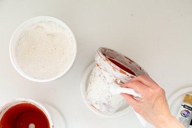 applying plaster to DIY aged terra cotta pots