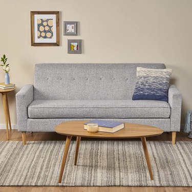 light gray couch with buttons