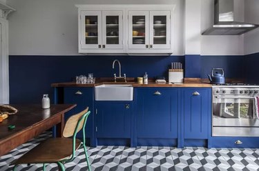 Kitchen with royal blue cabinets, gray tile floor.