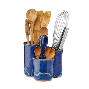 utensil caddy with wood spoons and whisk and tongs