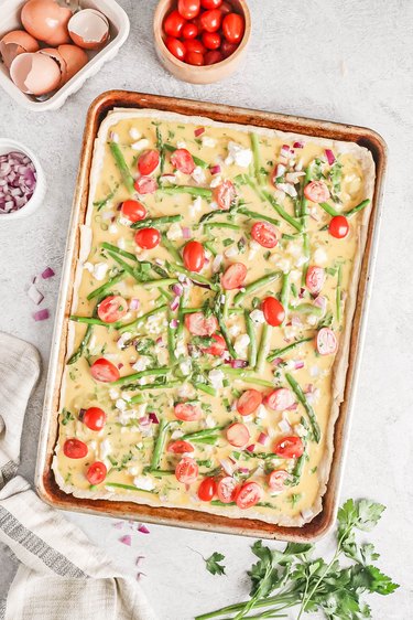 Spring vegetable sheet pan quiche before baking