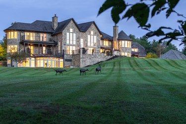 stone lodge and hilly lawn