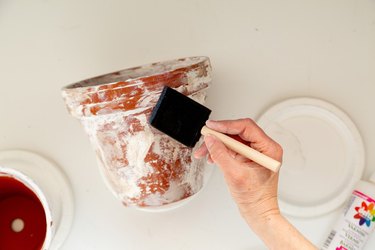 applying sealer to DIY aged terra cotta pots