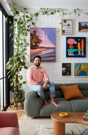 designer Jono Fleming sitting on sofa in living room