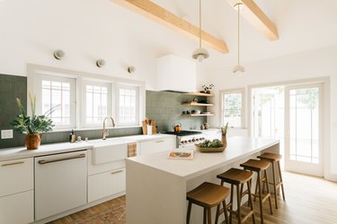 modern white kitchen with sage green tiled backsplash