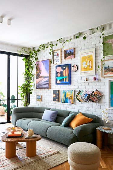 Jono Fleming living room with curved sofa and gallery wall