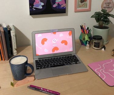 desk with laptop and latte and plants