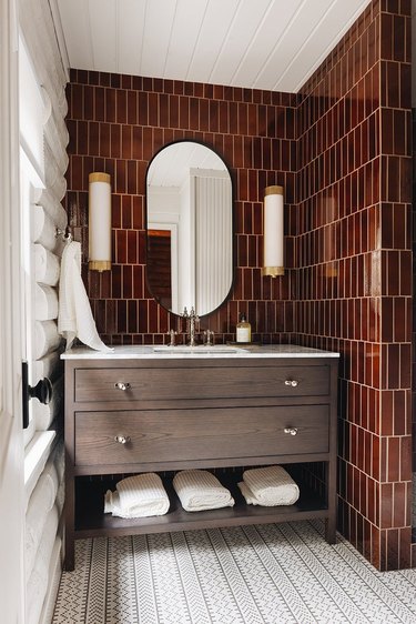 long, cylindrical sconces in bathroom