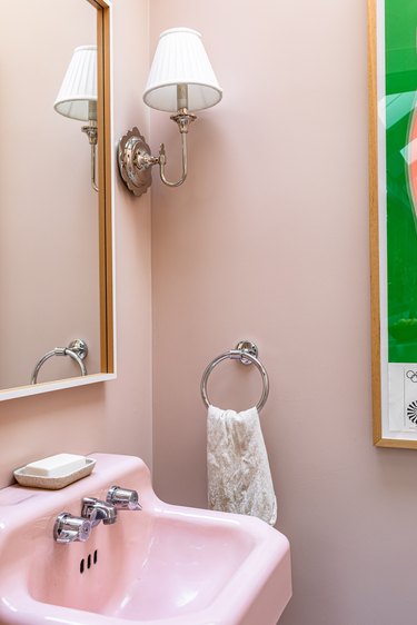 bathroom with pink sink and silver light