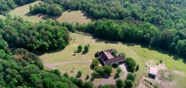 overhead view of home with trees and nature nearby