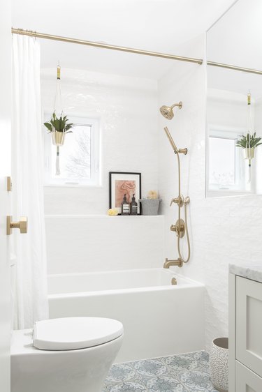 Modern boho bathroom with macrame plant hanging, mosaic tile and brass fixtures